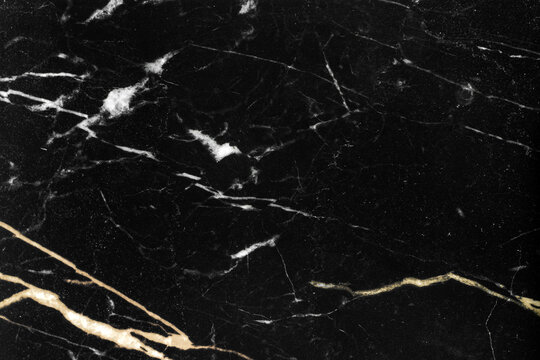 Gold and white patterned natural of dark black marble texture background for product design