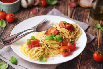 Italian pasta spaghetti with basil and cherry tomatoes	