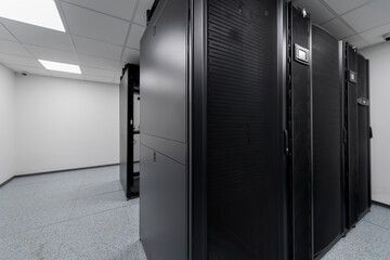 Data Center With Multiple Rows of Fully Operational Server Racks. Modern Telecommunications, Cloud Computing, Artificial Intelligence, Database, Supercomputer Technology Concept.