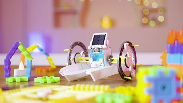 zoom in shot of DIY Solar robot on table with kids toys at home - concept of puzzled robotic game and scientific experiment for children