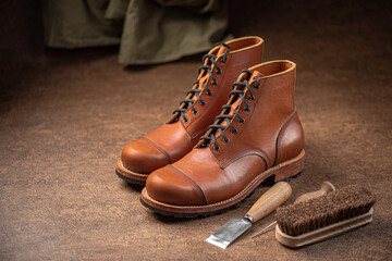 Fototapeta na wymiar Handcrafted brown leather shoes with cobbler tools on the backgound