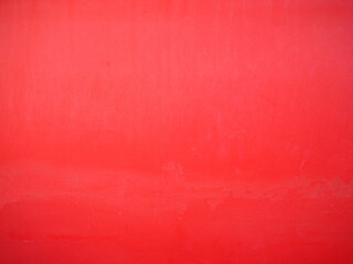 Plastered walls painted bright red to use as wallpaper. The vintage-style blank red wall is perfect for advertising.
