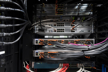 network server room closeup on fiber optic hub or switch for digital communications and internet in...