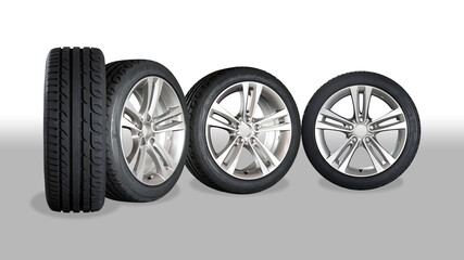 Obraz premium Set of four wheels on grey - white background. New tires on aluminum wheel rims. No logo visible, only tire labeling visible.