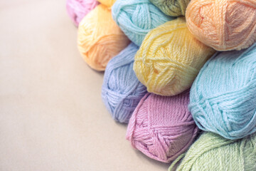 Vintage Knitting needles and yarn on wooden background. natural wool knitting background. knitting yarn for handmade winter clothes. Close Up of yarn balls. Rainbow colors. Place for text, banner.