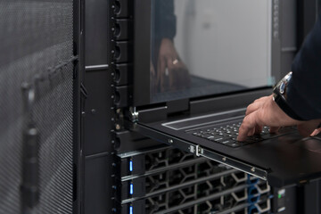 Close up on Data Center Engineer hands Using keyboard on a supercomputer Server Room Specialist...
