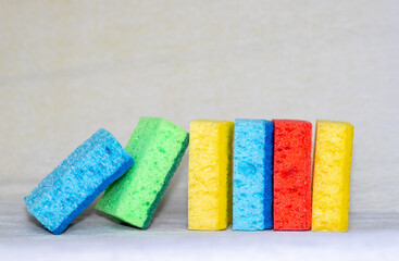 Multicolored sponges for cleaning. blue, green, red, yellow, blue and green colors. space for text.
Kitchen cleaning set sponge background.  - obrazy, fototapety, plakaty