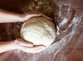 Female hands making dough. Dough kneading process. Dough based on natural sourdough. Wheat dough. Fermentation.	