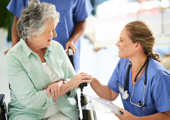 Cropped shot of an attractive female nurse discussing treatments with her wheelchair-bound senior patient in the hospital