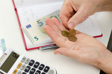 The pensioner is calculating the profit. Pension deposits. Euro cents in old female hands.
