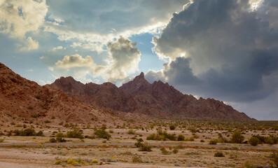 Aerial view rock mountains in the high desert in the middle of the highway of Arizona