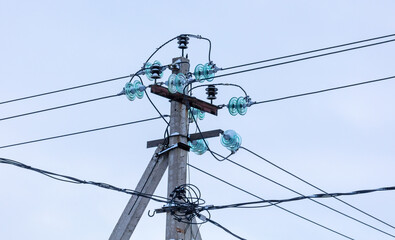 A pillar with electric wires against the background of the sky.
