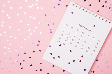 Pink background with purple glittering hearts. Calendar for February. Flat style. Valentine's day concept.