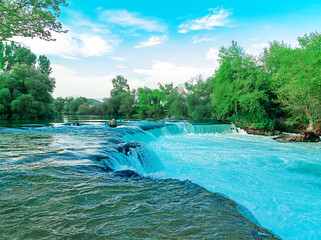Manavgat Waterfall in Turkey. A beautiful waterfall in the summer among trees and shrubs