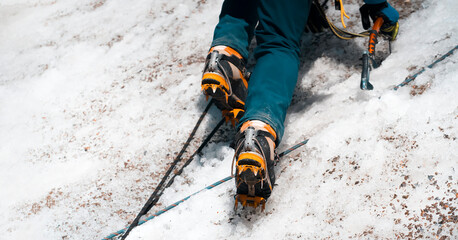 Man is climbing with crampons on the glacier.