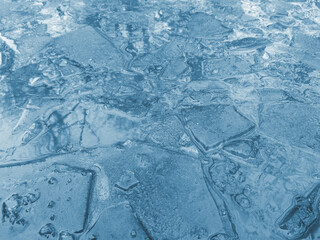 Cracked ice in a puddle.