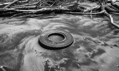Black & White Tyre buried in the Sand