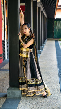 Chinese Girl wearing an Indian outfit posing