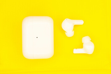 Wireless headphones white, photo on a yellow background