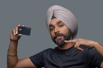 Indian male cardholder in the turban demonstrating his payment system