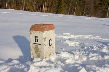 Czech-Polish border stone in the snow-covered landscape