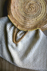 Wicker basket and soft kniited blanket. Hygge at home. Flat lay.