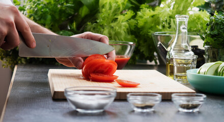 close-up male hands are preparing food in the interior of a kitchen.