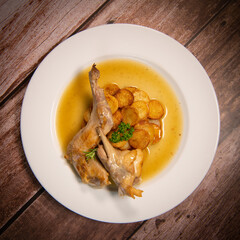 Rabbit casserole recipe with olives and herbs, sauteed potatoes. High quality photo