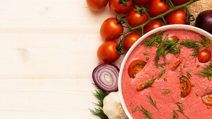 Italian cream tomato soup on a wooden background. Copy space. brush cherry tomatoes and onions.