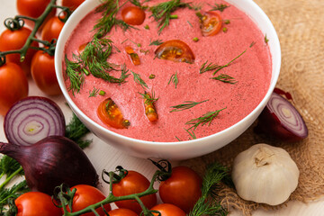 vegetarian soup of fresh cherry tomatoes on a wooden table. vegetarian food. dishes made from fresh products.