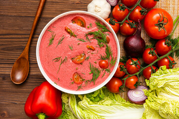Fragrant tomato soup of cherry tomatoes with the addition of herbs. on a wooden table.  a delicious dish made from fresh products.