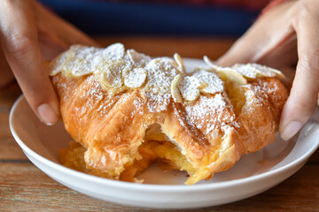 Close-up view, Almond Croissant Baked crisps topping with icing sugar.