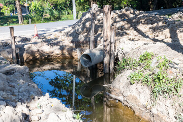 Concrete circular run-off pipe discharging water. sewage pipe polluting the river. Sewage or domestic wastewater or municipal wastewater that is product by community of people.