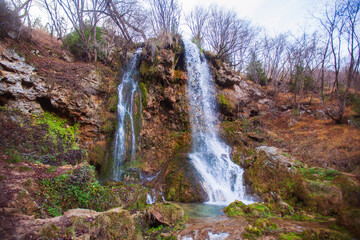 Beautiful forest waterfall, autumn day. Gostilje waterfall at mountain Zlatibor, Serbia.