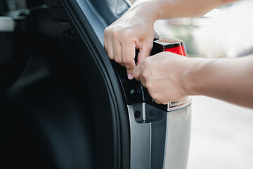 Close up hand a man use block wrench remove bolt of car tail lights are being disassembled with the car body Maintenance of lighting systems for safety concept