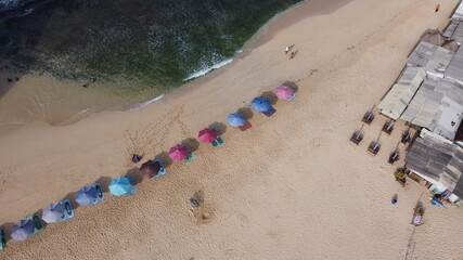 Aerial view of white sand beach and colorful umbrella. Top view of beautiful tropical beach