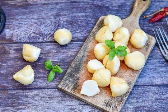  Smoked mini  traditional italian provola  cheese  on wooden background