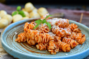  Home made italian   radiatori bolognese fresh   pasta  on rustic background. Mediterranean food concept