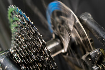 Cassette and chain of a mountain bike close-up on a black background. Professional bicycle repair in the workshop. Studio photo of a sports bike.