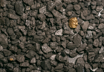 hard coal in the pile. a piece of gold among the coal. extracted underground.
