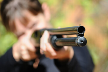 Woman sighting shot gun close focus.