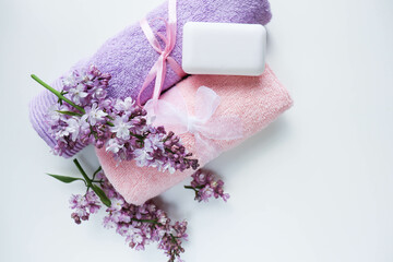 spa theme. beauty and health. a set of towels, white soap and a lilac branch. color of the year 