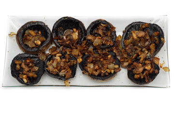 Mushrooms stuffed with garlic and onion, Spanish food. Isolated on white background. Selective focus.