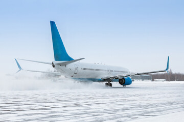 Taxiing of a passenger aircraft on the airport apron in a snow blizzard