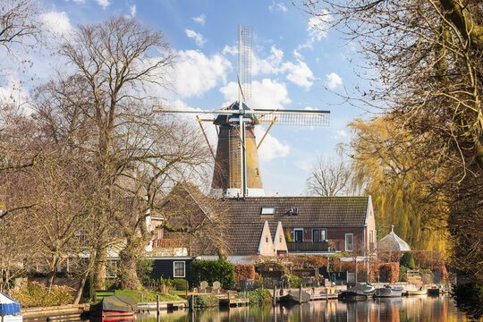 River Vecht with a windmill in the background in the village of Loenen aan de Vecht.