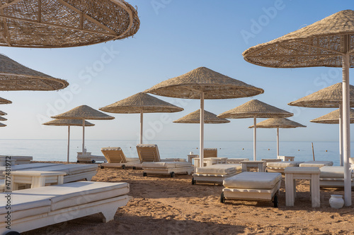 Straw parasols and loungers on a Red Sea resort beach