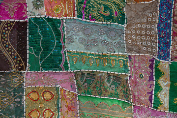 Detail old colorful patchwork carpet in India. Close up
