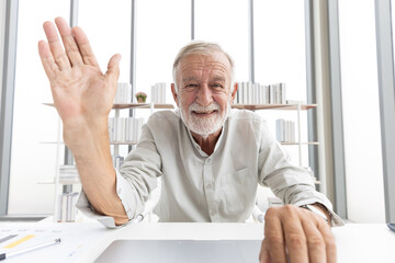 Fototapeta premium senior man typing keyboard on laptop computer and say hello or goodbye with someone from chat online