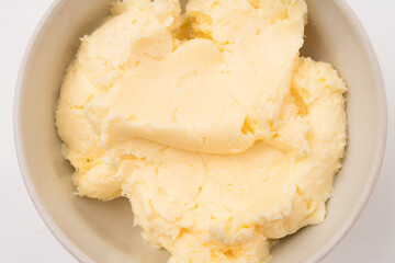 Bowl with butter cream on a light background.