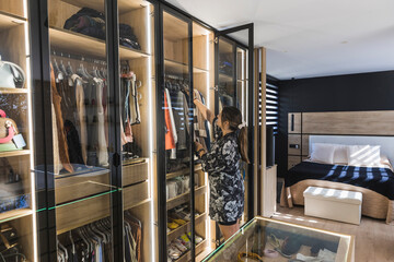Woman in bedroom near wardrobe